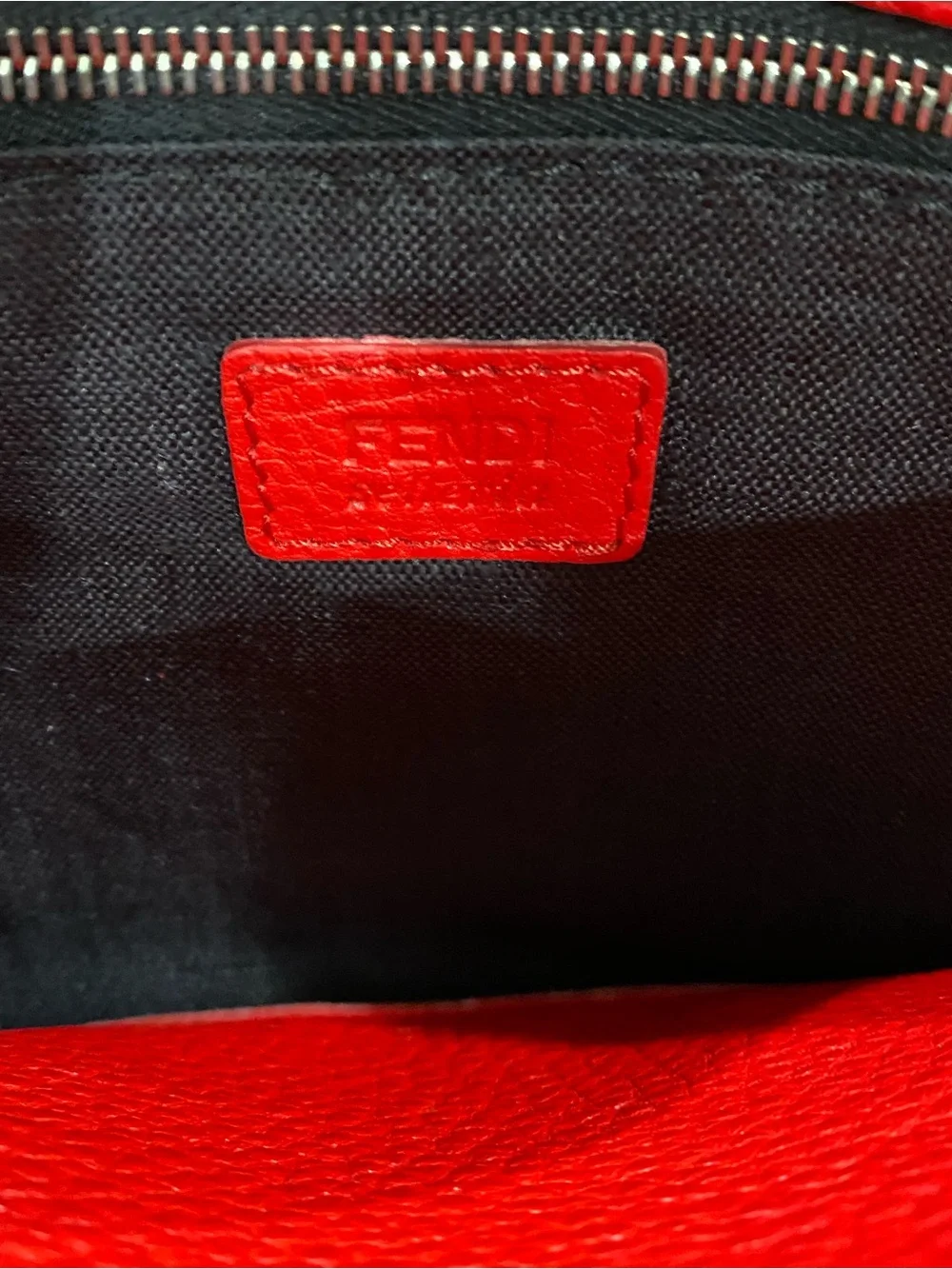 Fendi Selleria flat clutch bag with red stitching and red leather handle